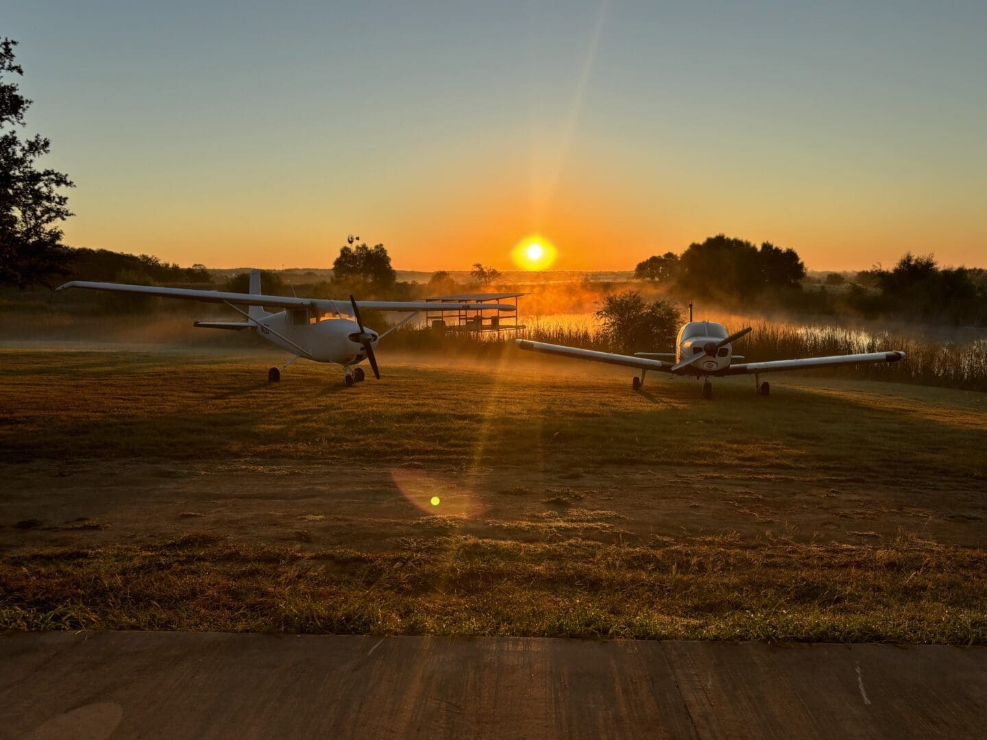 A group of small airplanes on the ground.