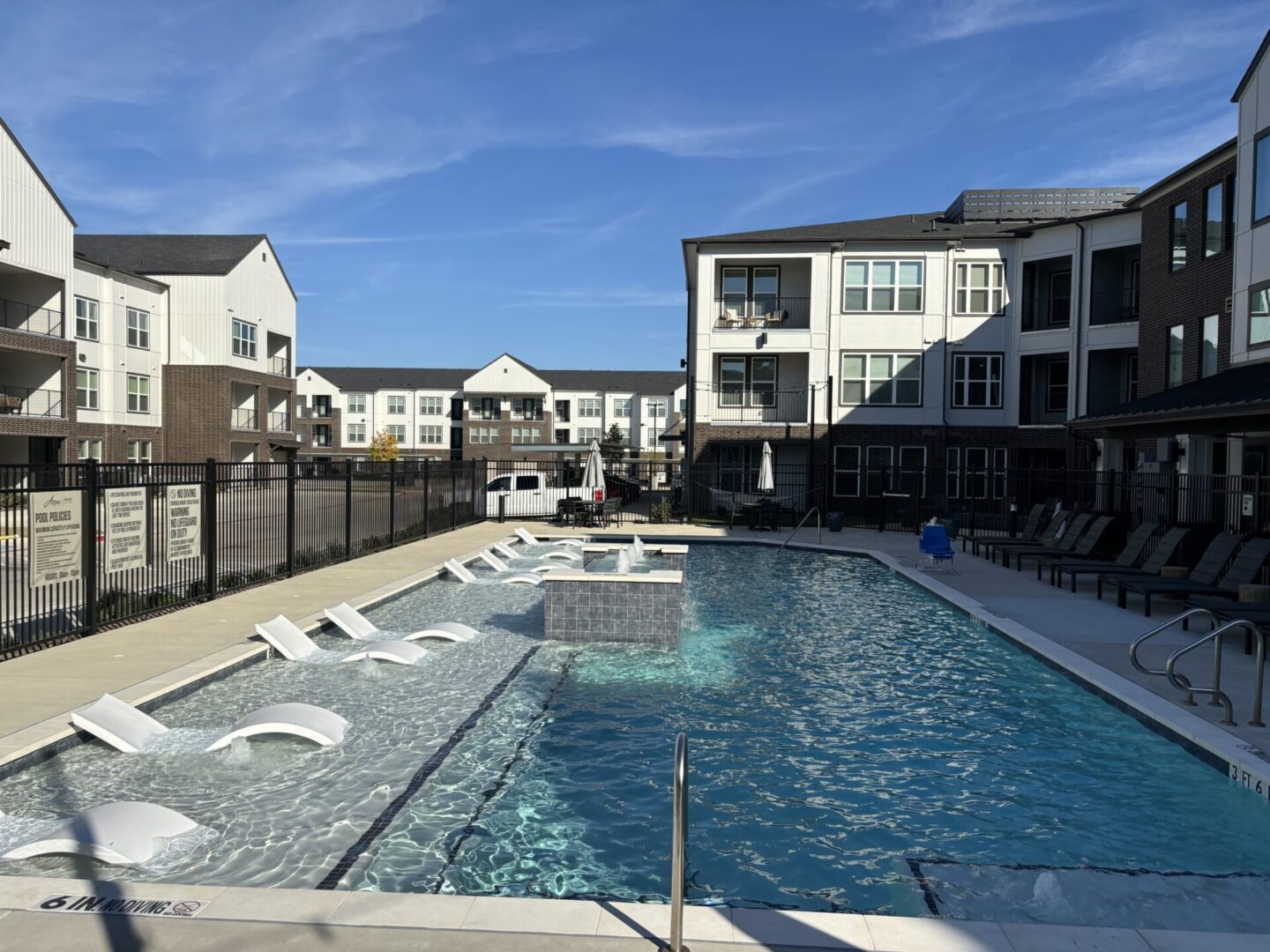 A pool with many chairs in it