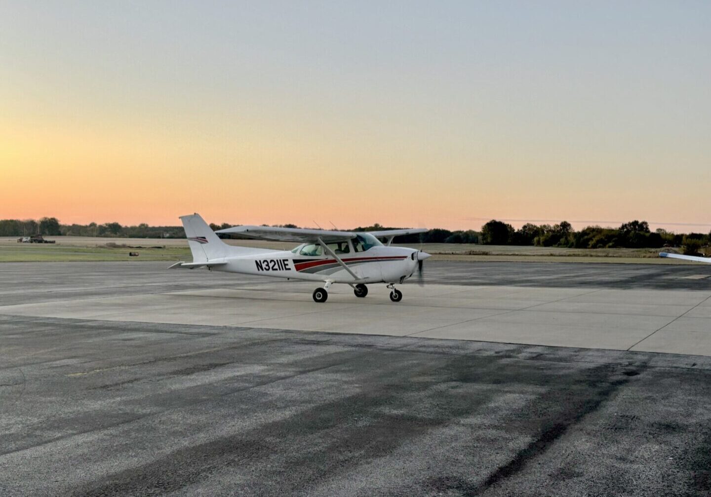 A small plane sitting on top of an airport runway.