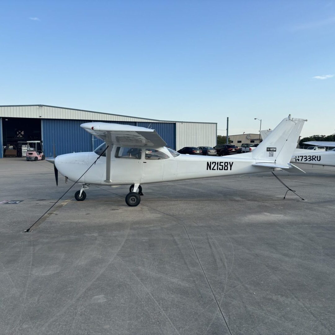 A small white plane sitting on top of an airport runway.