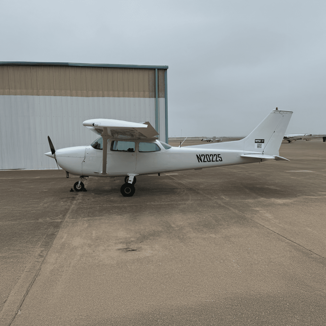 Small airplane parked on airport tarmac.